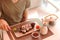 A young handsome man is eating sushi rolls with chopsticks in a Japanese restaurant and drinking tea