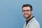 Young handsome man with great smile wearing fashion eyeglasses against neutral background with lots of copy space