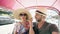 Young handsome man in hat with his girlfriend ride on traditional thai bus songteo . Couple travel Thailand during their