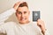 Young handsome man holding Australia Australian passport over isolated white background stressed with hand on head, shocked with