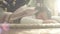 Young handsome man lying on the carpet close laptop and falling asleep on the floor isolated on a sunny background