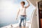 Young handsome man preparing boat to start a journey, standing on the boat