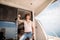 Young handsome man preparing boat to start a journey, standing on the boat