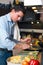 Young handsome man preparing lunch