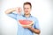 Young handsome man with red eyeglasses on his head holding ripe watermelon showing dislike sign on isolated white