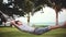 Young handsome man relaxing on hammock on beautiful tropical beach. Vacation concept. 1920x1080