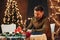 Young handsome man sits by the table and waits for girlfriend for romantic dinner in restaurant