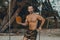 Young handsome man standing on the wooden swing