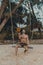 Young handsome man standing on the wooden swing