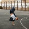 Young handsome man in stylish denim dress dancing hip hop.