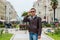 Young handsome man in sunglasses, tourist, on the pedestrian Aristotle Street in the center of the Thessaloniki, Greece