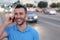 Young handsome man talking on his smart phone, traffic jam in background with copy space