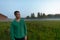 Young handsome man thinking against grass field with fog in the break of dawn