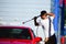 Young handsome man washing car