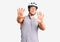 Young handsome man wearing bike helmet afraid and terrified with fear expression stop gesture with hands, shouting in shock