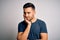 Young handsome man wearing casual t-shirt standing over isolated white background thinking looking tired and bored with depression