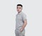 Young handsome man wearing grey polo shirt isolated on background