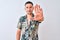 Young handsome man wearing Hawaiian summer shirt over isolated background doing stop sing with palm of the hand