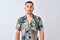 Young handsome man wearing Hawaiian summer shirt over isolated background Relaxed with serious expression on face