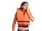 Young handsome man wearing nautical lifejacket looking stressed and nervous with hands on mouth biting nails