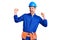 Young handsome man wearing worker uniform and hardhat dancing happy and cheerful, smiling moving casual and confident listening to