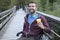 Young handsome man on a wheelchair drinking coffee to go