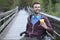 Young handsome man on a wheelchair drinking coffee to go