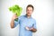 Young handsome showing a whole bunch of salad and sliced bacon on  white background