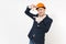 Young handsome smiling businessman in dark suit, protective construction orange helmet making hands photo frame gesture