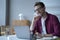 Young handsome smiling german man office worker in glasses enjoying video call on laptop computer