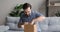 Young handsome smiling man unpacking small carton box.