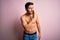 Young handsome strong man with beard shirtless standing over isolated pink background hand on mouth telling secret rumor,