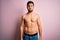 Young handsome strong man with beard shirtless standing over isolated pink background puffing cheeks with funny face