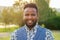 A young and handsome stylish model afro- american man in a stylish suit in a summer park . latino american hispanic