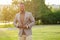 A young and handsome stylish model afro- american man in a stylish suit in a summer park . latino american hispanic