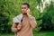 A young and handsome stylish model afro- american man in a stylish suit in a summer park . latino american hispanic