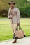 A young and handsome stylish tailor model afro- american man in a stylish suit in a summer park . latino american