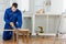 Young handyman cutting a wooden board