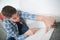 Young handyman installing carpet with cutter