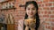 Young happy arabian woman enjoy fragrant drink in cafe smiling relaxed Indian girl restaurant customer enjoying
