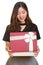 Young happy Asian businesswoman opening gift box ready for Valen