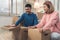 Young happy Asian couple moving to their new home, open boxes to check old objects from old home. Lifestyle couple move new home