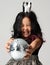 Young happy asian girl kid smiling in silver crown and give away disco ball decoration