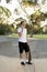 Young happy and attractive American man 30s standing holding skate board after sport boarding training session talking on mobile p