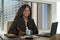 Young happy and attractive black African American businesswoman working confident at computer desk smiling satisfied in financial