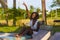 Young happy and attractive black African American woman lying on pool hammock at tropical beach resort chilling relaxed drinking
