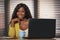 Young happy and attractive black afro American business woman smiling cheerful and confident working at office computer desk