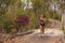 Young happy attractive and exotic Asian Indonesian runner woman in jogging workout outdoors at countryside road track nature