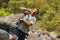 Young happy and attractive man with travel backpack hiking in river at forest feeling free enjoying nature and fresh environment