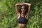 Young happy and attractive middle eastern woman with curly hair and athletic body stretching arms outdoors before running workout